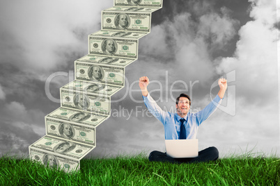 Composite image of businessman cheering with laptop sitting on f