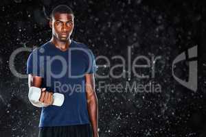 Composite image of portrait of a casual man lifting dumbbells