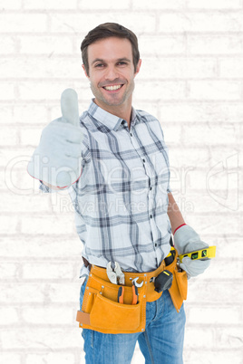 Composite image of happy handyman gesturing thumbs up