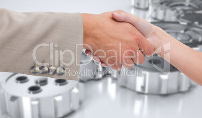 Composite image of close up of female and male hand shaking