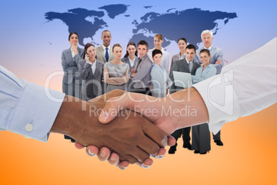 Composite image of close-up shot of a handshake in office