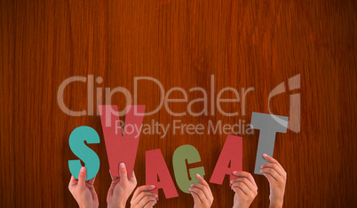 Composite image of hands holding up svagat Composite image of hands holding up svagat