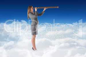 Composite image of businesswoman looking through a telescope