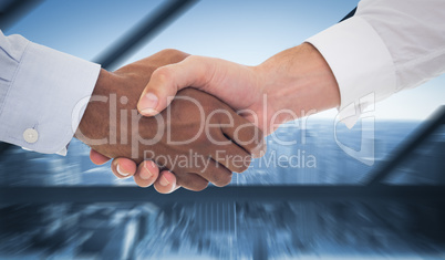 Composite image of close-up shot of a handshake in office