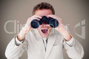 Composite image of positive businessman using binoculars