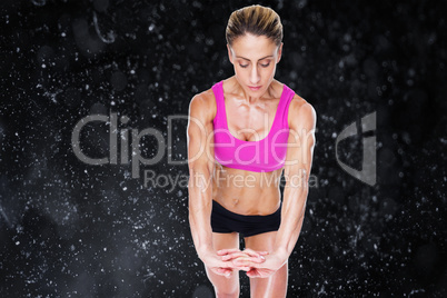 Composite image of female bodybuilder flexing with hands togethe