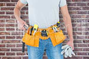 Composite image of technician holding gloves and hammer