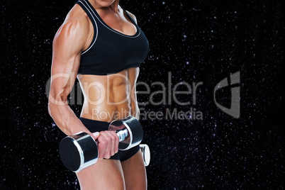 Composite image of female bodybuilder working out with large dum