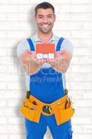 Composite image of portrait of happy construction worker holding