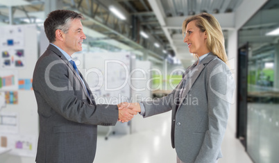 Composite image of pleased businessman shaking the hand of conte