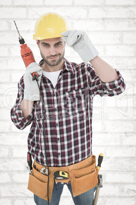 Composite image of confident handyman holding drill machine