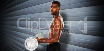 Composite image of portrait of a serious fit young man lifting b