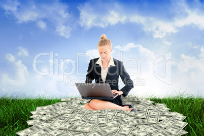 Composite image of businesswoman using laptop