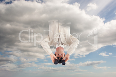 Composite image of confident businessman with binoculars