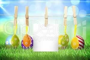 Composite image of hanging easter eggs