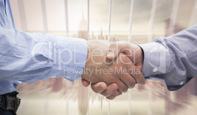 Composite image of two men shaking hands