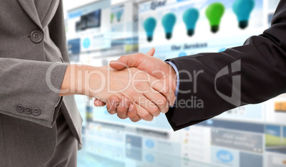 Composite image of close up of two businesspeople shaking their