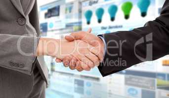 Composite image of close up of two businesspeople shaking their