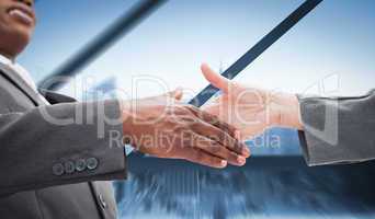 Composite image of businessman going shaking a hand
