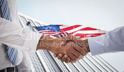 Composite image of close-up shot of a handshake in office