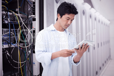 Composite image of male looking at his tablet computer