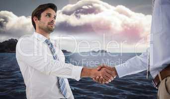 Composite image of two businessmen shaking hands in office