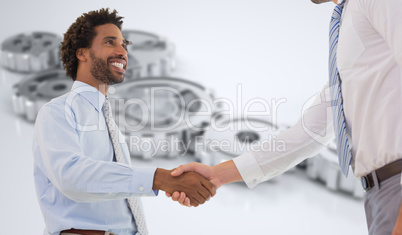 Composite image of two businessmen shaking hands in office Composite image of two businessmen shaking hands in office