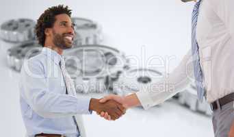 Composite image of two businessmen shaking hands in office