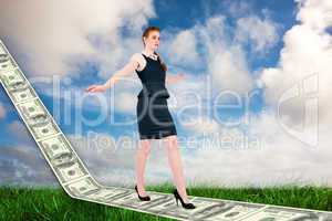 Composite image of businesswoman doing a balancing act