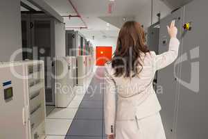 Composite image of brunette businesswoman standing back to camer