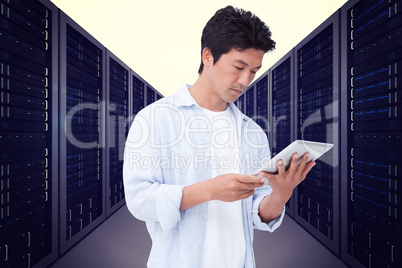 Composite image of male looking at his tablet computer