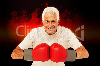 Composite image of senior man in boxing gloves