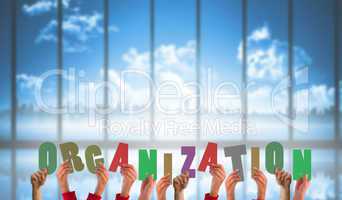 Composite image of hands holding up organization