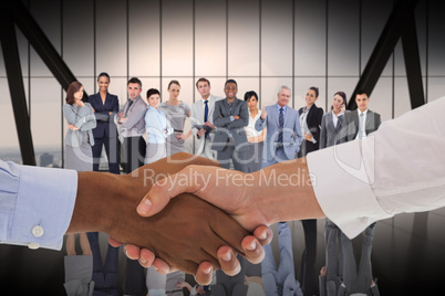 Composite image of close-up shot of a handshake in office