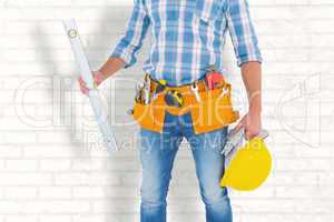 Composite image of manual worker holding spirit level