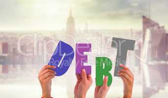 Composite image of hands holding up debt