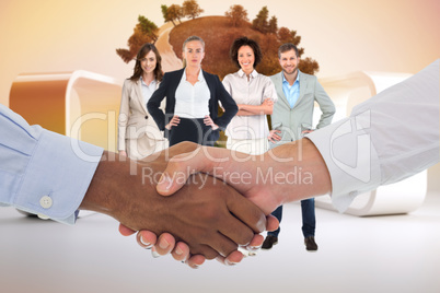 Composite image of close-up shot of a handshake in office