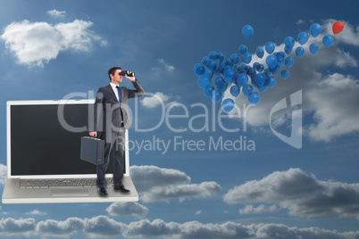 Composite image of businessman looking through binoculars