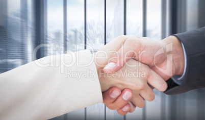 Composite image of close up on partners shaking hands