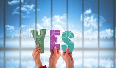 Composite image of hands holding up yes