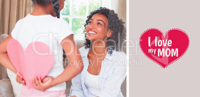 Composite image of pretty mother sitting on couch with daughter