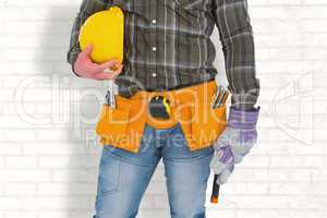 Composite image of manual worker wearing tool belt while holding