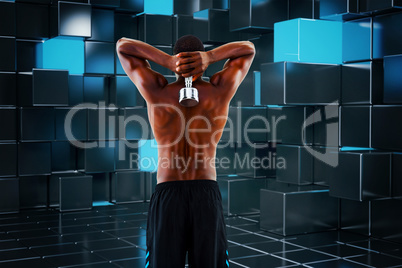 Composite image of rear view of a fit shirtless man lifting dumb