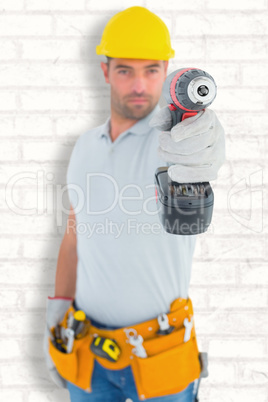 Composite image of portrait of handyman using power drill