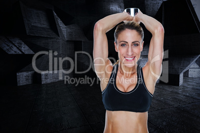 Composite image of female happy bodybuilder working out with lar