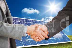 Composite image of two people having a handshake in an office