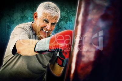 Composite image of portrait of a determined senior boxer