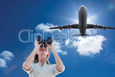 Composite image of businesswoman looking through binoculars