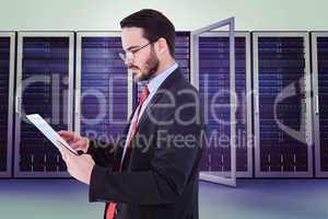 Composite image of businessman scrolling on his digital tablet