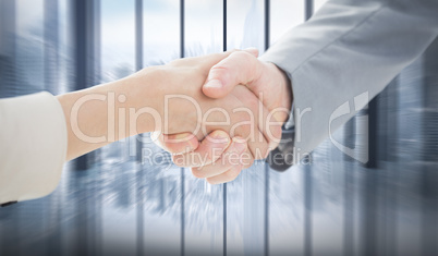 Composite image of closeup of shaking hands after business meeti